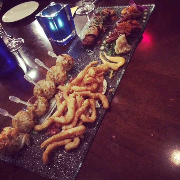 Photo taken at Deep Blu Seafood Grille by Matthew R. on 11/25/2014