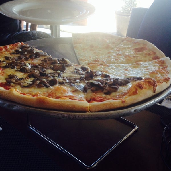 Foto diambil di Positano Restaurant &amp; Pizzeria oleh Cecilia N. pada 3/24/2014