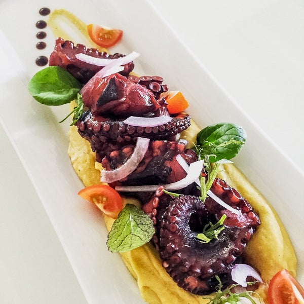 One of the many tasty delicacies that Thioni Restaurant has to offer. Summer Flavoured Octopus in red wine served with fava Santorini!