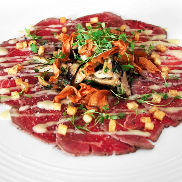 Speciality includes Beef loin carpaccio, Braised squid with dates & Butter crunch cake