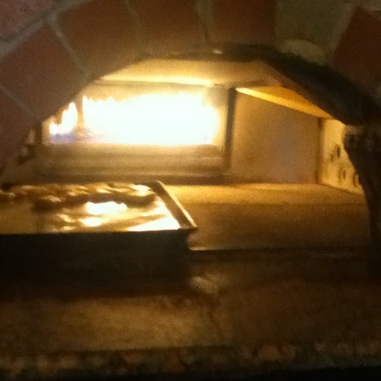 Photo taken at Bellini Italian Restaurant &amp; Brick Oven Pizza by Miss A. on 4/21/2012