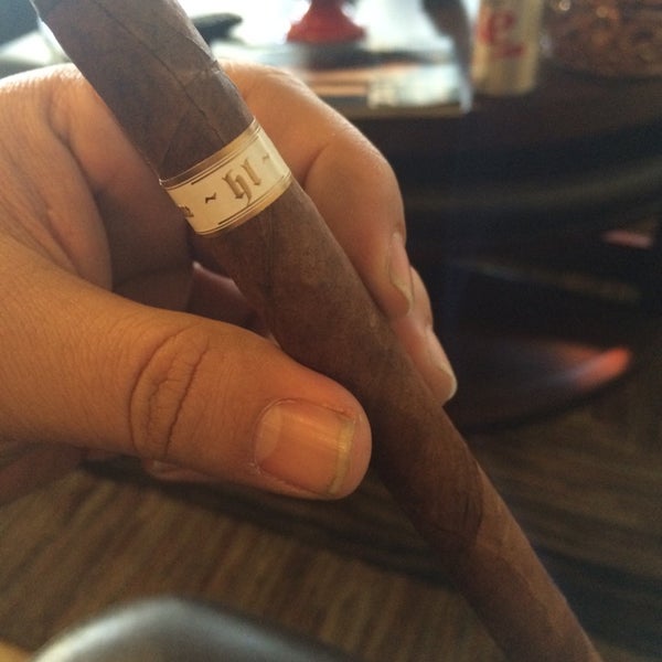 Photo taken at En Fuego Cigars &amp; Lounge by Tracy M. on 11/29/2014