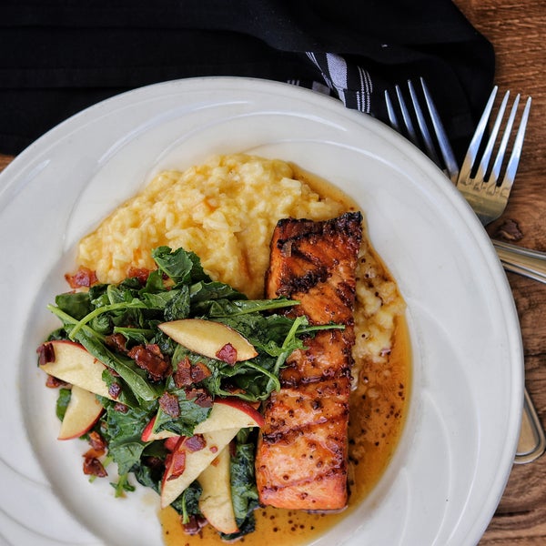 Enjoy fresh Faroe Island salmon with flavors from our seasoned grill topped with a sweet and savory maple glaze served with butternut squash risotto and apple kale salad!