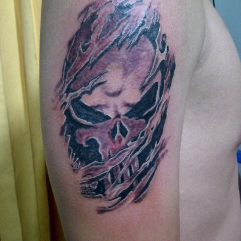 Punisher Skull Tattoo Ripping Through Skin