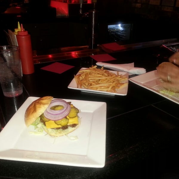 Photo taken at Grind Burger Bar &amp; Lounge by Travis S. on 5/18/2013