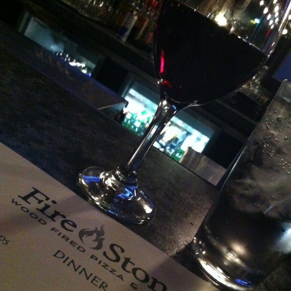 Photo taken at Fire Stone Wood Fired Pizza &amp; Grill by Jared C. on 12/20/2012