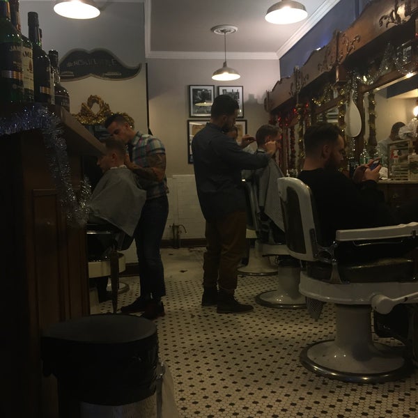 Photo taken at Neighborhood Cut and Shave Barber Shop by Kevin R. on 12/18/2014