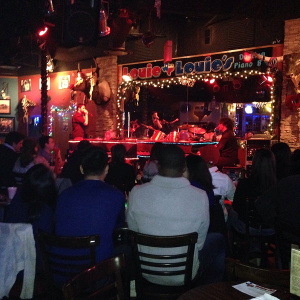 Photo taken at Louie Louie&#39;s Dueling Piano Bar by Brian F. on 12/28/2014