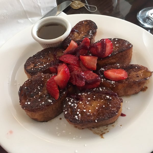 $18 for 1.5 hours of boozy brunch. Omelette comes with house fries, and the French toast is topped with strawberries.