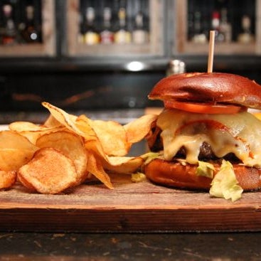 The Bootlegger burger features a 1/2 lb patty, literally dripping juice when it arrives, covered in zesty house sauce, muenster cheese, whiskey onions, crimini mushrooms, bacon, & a pretzel bread bun.