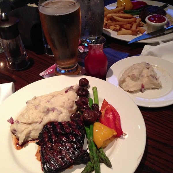 Photo taken at The Keg Steakhouse + Bar - Morgan Creek by James P. on 3/15/2013