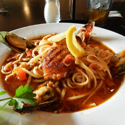 Check out this delicious seafood entree!  Rovali's Ciappino!!  Baked Salmon, baby clams, sauteed shrimp, scallops and fresh mussels all on a bed of linguini!