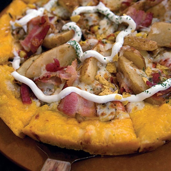 The signature pizza here is the Potato Gold, which features a tomato sauce base for a smattering of odd toppings: mushrooms, ground beef, corn, onions, potatoes, bacon, chips and a swirl of sour cream