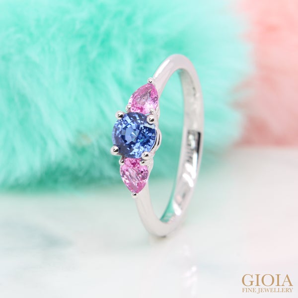 Trilogy Sapphire Proposal Ring Featuring round brilliant Ceylon blue sapphire matching with sweet pink pear-shaped sapphire, custom made in platinum ring.
