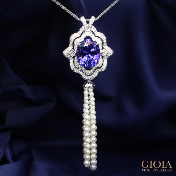 Art Deco Tanzanite Pendant An exceptional pendant design features a vivid violetish blue tanzanite in an oval modified brilliant shape with an art deco symmetrical and geometric look.
