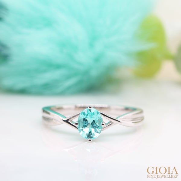 Paraiba Tourmaline Proposal Ring Minimalistic twisted design with matt and polished bands, this proposal ring showcases a delicate defining twist to the centre Paraiba Tourmaline.