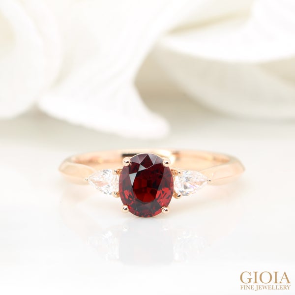 Red Spinel Proposal Ring Crimson red spinel crafted in a trilogy design with side pear fancy diamond.