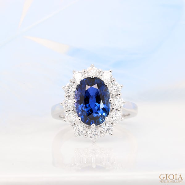 Blue Sapphire Engagement Ring Featuring an unheated vivid Royal Blue sapphire, exquisite and luxurious piece of fine jewelry. Timeless elegance design with surrounding round brilliance diamond