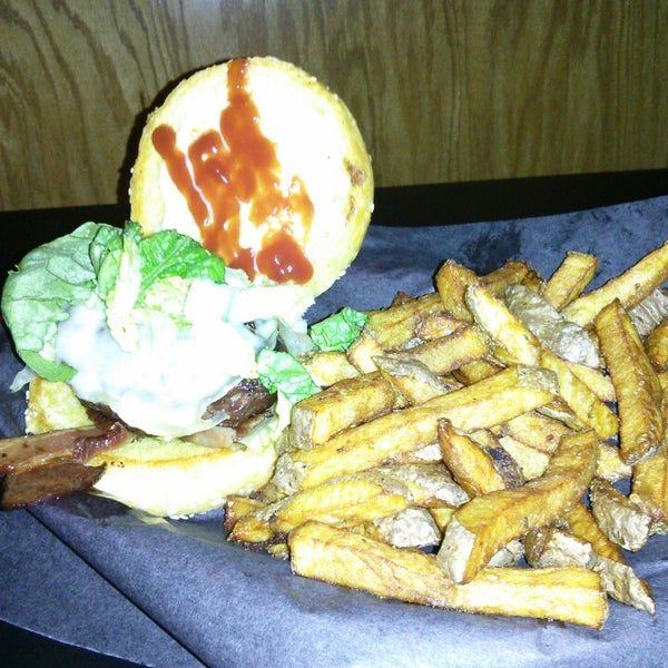 Photo taken at Woody&#39;s Burgers bar and grill by James S. on 2/14/2013