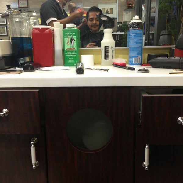 Photo taken at Manhattan Barber Shop by William O. on 11/25/2014