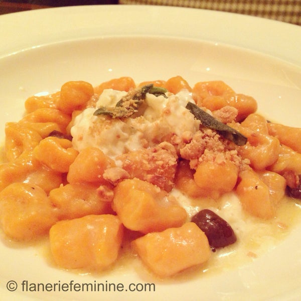 Divine carrot gnocchi topped with toasted nuts, black olives, and stracciatella cheese.