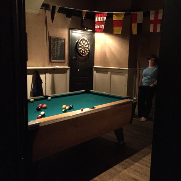 pool table and dart board in the middle room