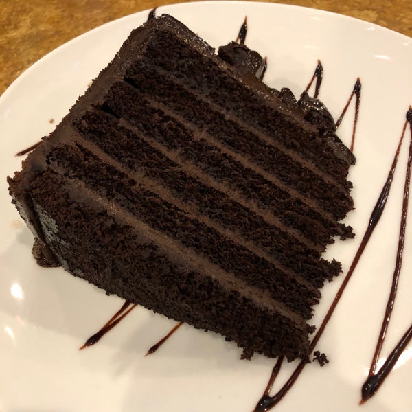 big fat chocolate cake has little pieces of chocolate cake as a topping