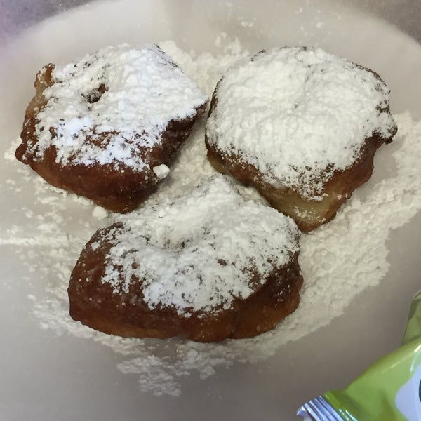 crispy fried zeppoli donuts with powdered sugar sold in threes or fives