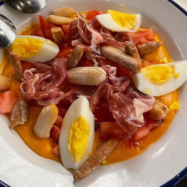tomate en salmorejo is a kind of tomato salad in a cold thick tomato soup. served with jamon iberico, boiled eggs, and bread crackers