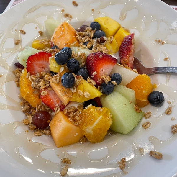 energy bowl with fresh fruit, greek yogurt, granola, and honey
