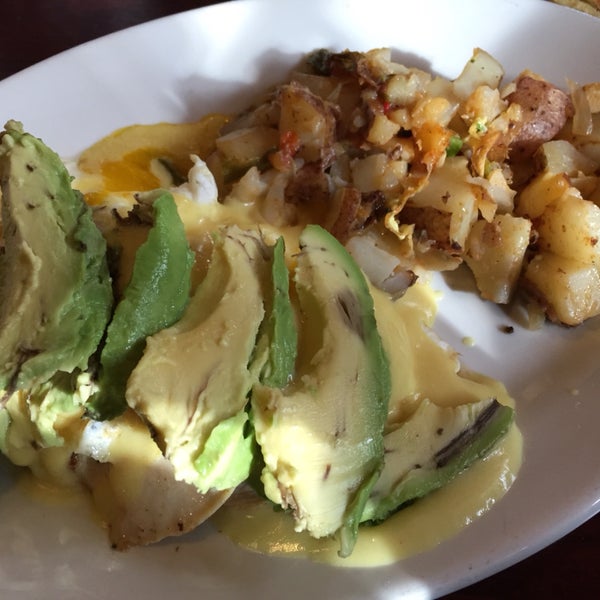 chicken, avacado, and egg with hollandaise sauce with home fries