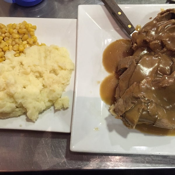 open face beef brisket sandwich with brown gravy, served here with mashed potatoes and corn