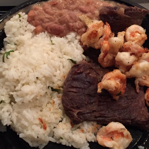 mar y tierra - grilled skirt steak with sautéed shrimp, lime cilantro rice, and refried beans