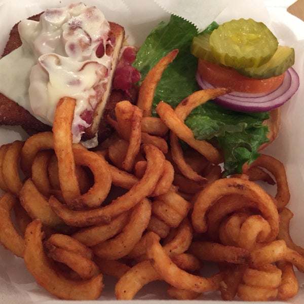 Vito Corleone's chicken club sandwich with fried chicken cutlet, cheese, and bacon, here with side of curly fries