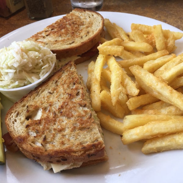 closed face tuna melt sandwich with cheddar and bacon on rye served with french fries