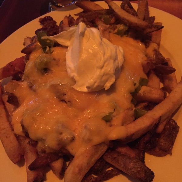 irish nachos - french fries slathered in nacho cheese, beef and bean chili, sour cream, and jalapeño. not a finger food