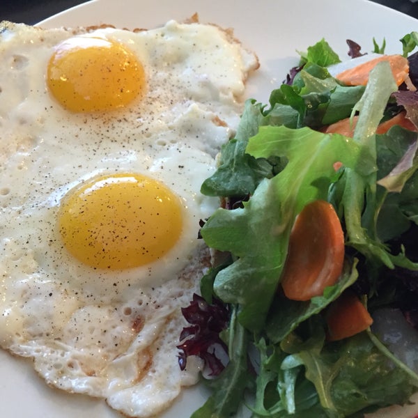 two eggs any style with green salad and sourdough toast