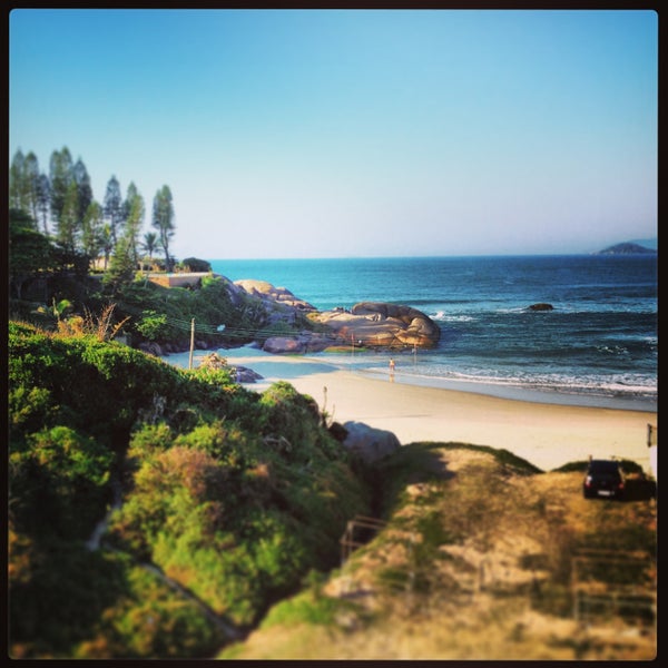 Photo taken at Praia da Joaquina by Alexandra Porto on 4/28/2013