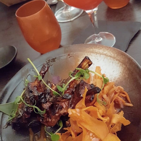 Tasty lamb chops, delicious mocktail with lychee and raspberry