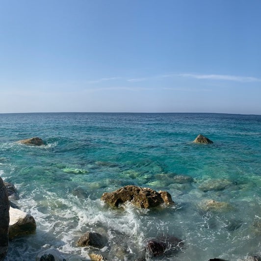 Photo taken at Lalaria Beach by Manfred B. on 7/9/2019