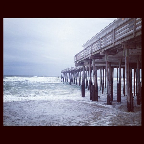 Photo taken at Kitty Hawk Pier by Justin H. on 4/5/2012