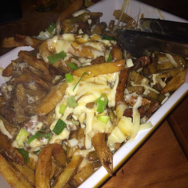 Photo taken at Canuck&#39;s Poutinerie by Gisele M. on 5/6/2015