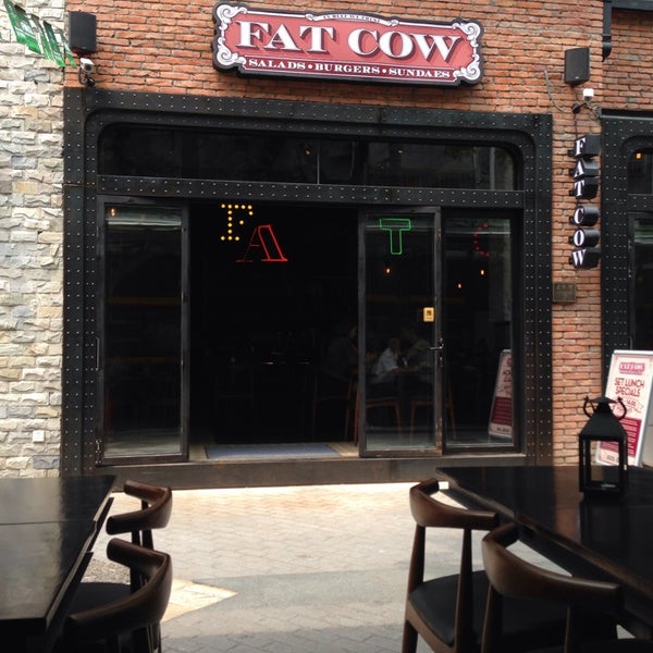 Photo taken at Fat Cow Burgers by Sandy T. on 5/16/2014