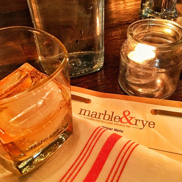Photo taken at marble &amp; rye, wood fired kitchen and whiskey bar by Shane T. on 1/18/2016