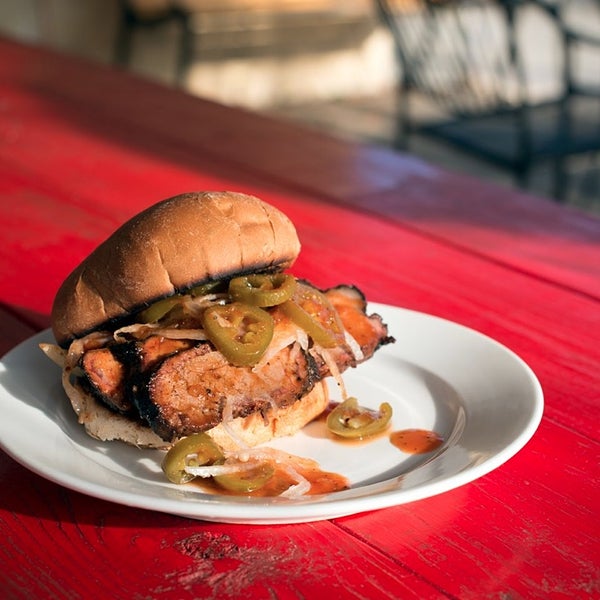 The brisket sandwich is piled with slices of gloriously smokey meat cut just the right thickness. It's finished off with some onions, jalapeños, and their tangy sauce on a toasted bun.