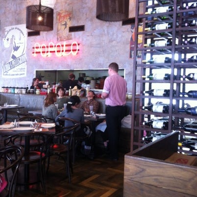 Photo taken at Popolo Italian Kitchen and Bar by Spatial Media on 7/21/2012