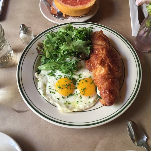Goat cheese croissant with eggs and greens