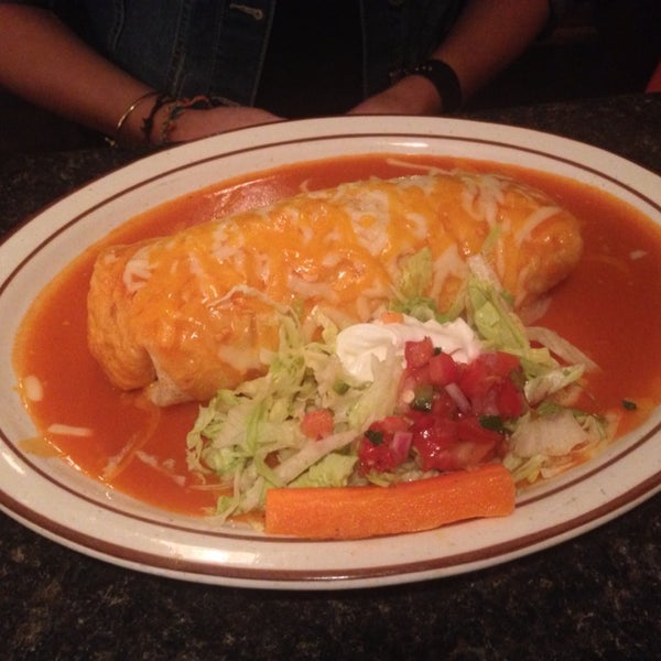 Shredded chicken wet burrito with red sauce.