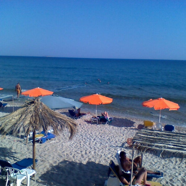 Photo taken at Stelakis Beach by Alejandra C. on 7/10/2013