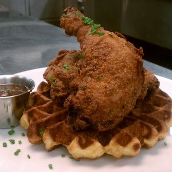 The restaurant offers a massive plate of simple fried chicken with a time-honored buttermilk waffle, hot sauce, and maple syrup -- every evening and during brunch.